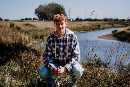 Boy outside, in plaid shirt 